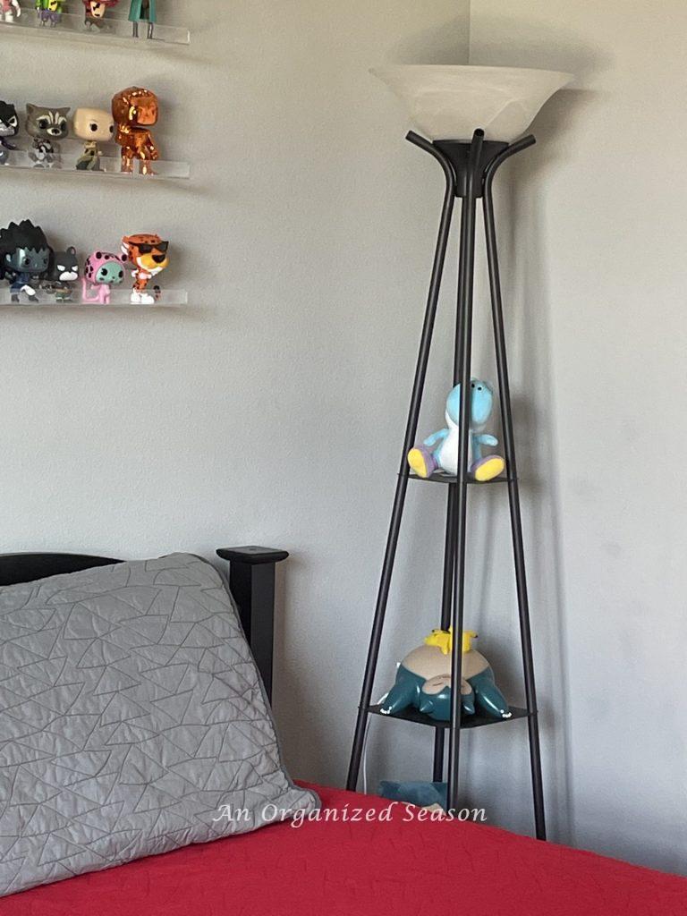 A floor lamp with shelves shows tips to organize collections in a kid's bedroom! 