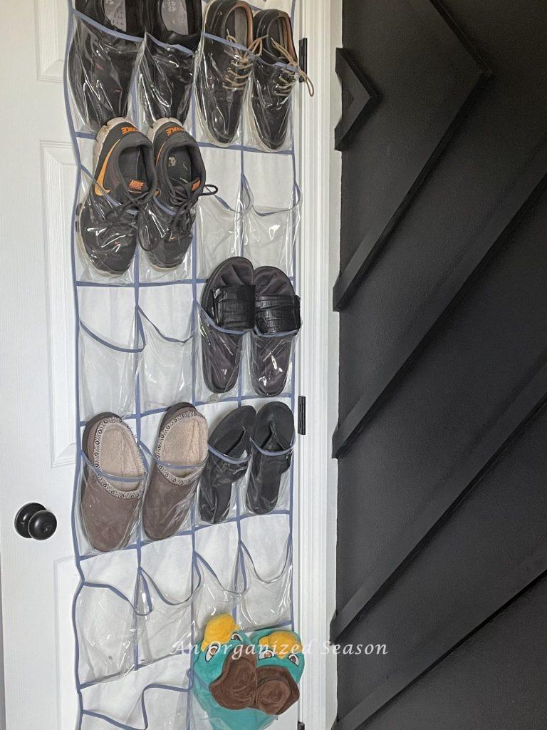 A shoe bag hanging on the back of a door showing tips to organize collections in a kid's bedroom!