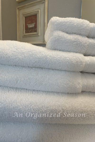 A stack of white towels in a bathroom.