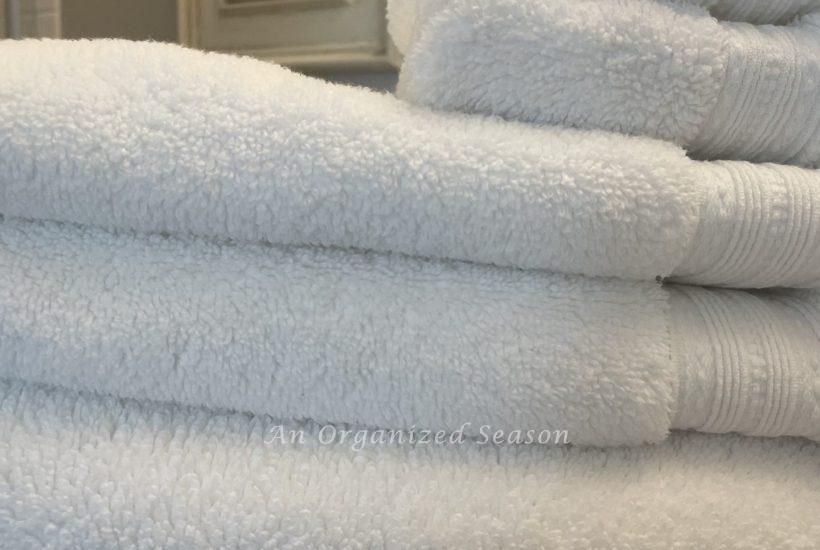 A stack of white towels in a bathroom.