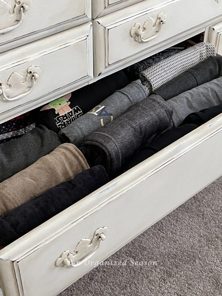 Organized leggings and sweats that are file folded in a drawer. 