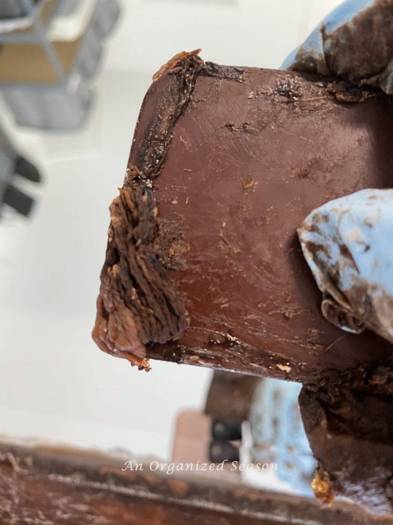 A plastic scraper with dried Citristrip stuck to the end.