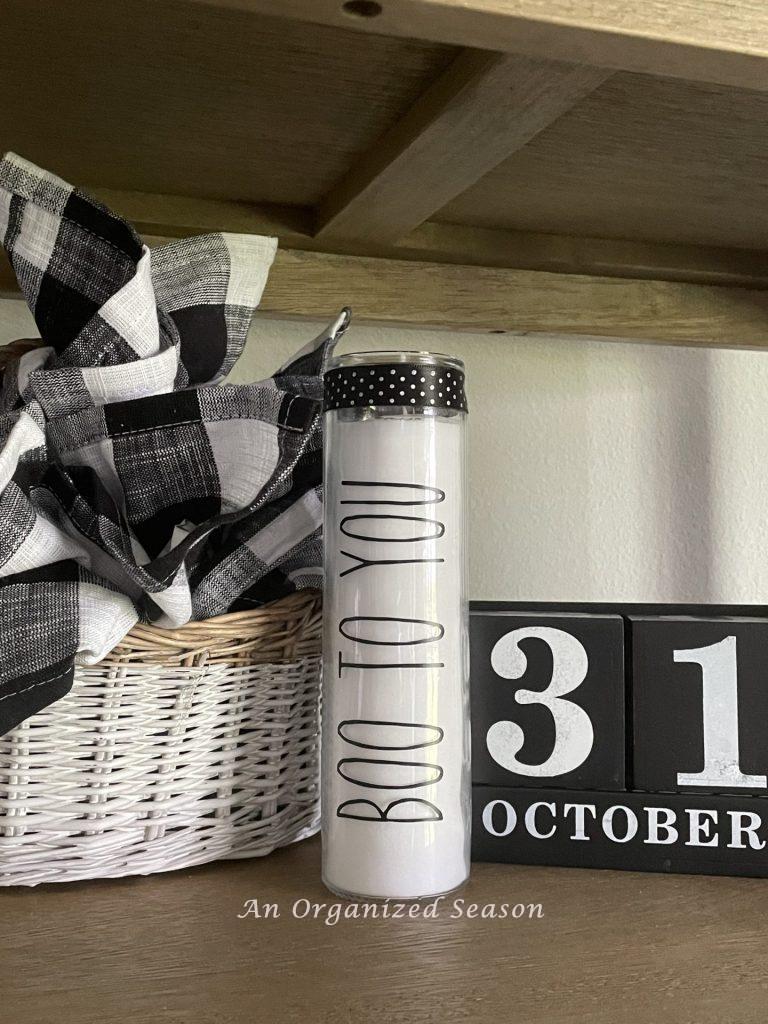 A duped Rae Dunn candle that says "Boo to You" is a fun DIY Fall decor craft.