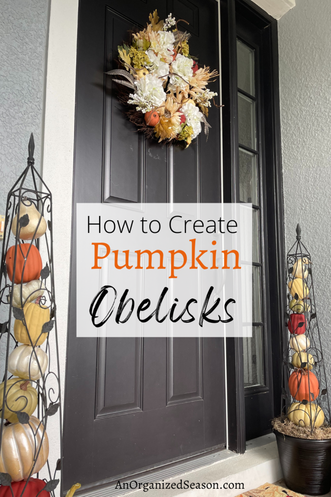 two pumpkin obelisks on either side of a front door.