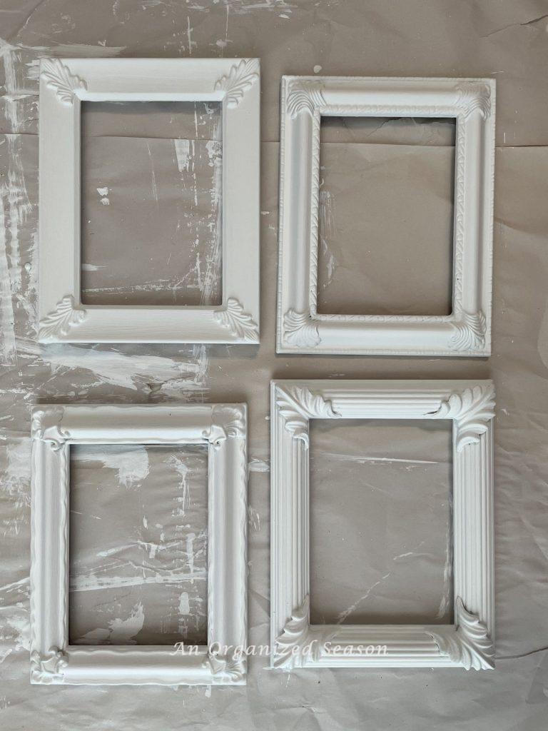 Four picture frames needed to make towel hooks that have been painted white.