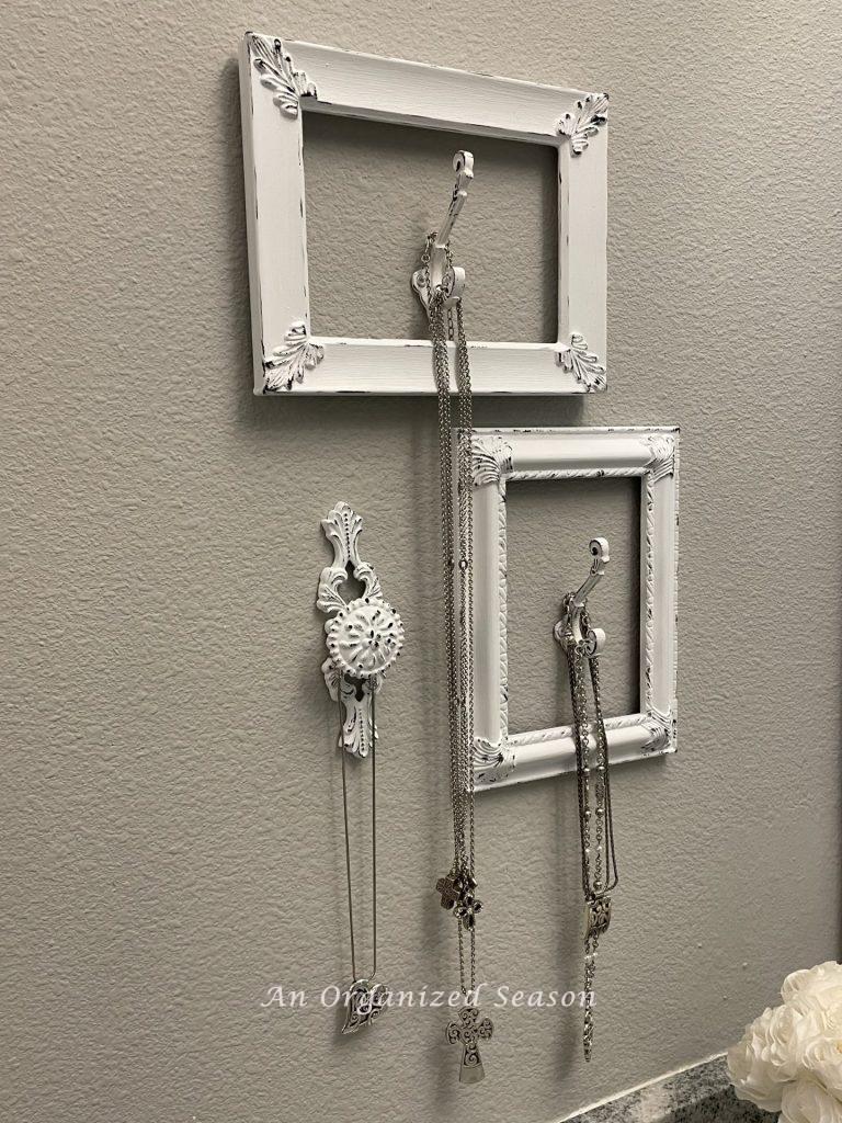 Decorative hooks holding jewelry. 