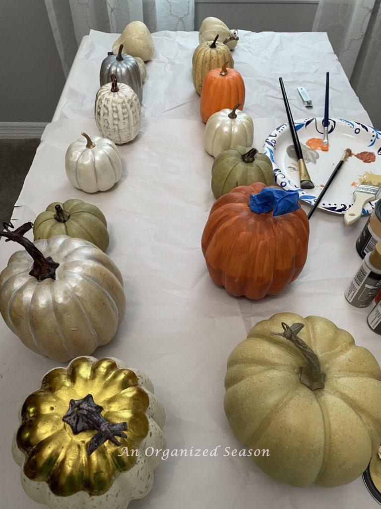 Pumpkins being painted coordinating colors. 