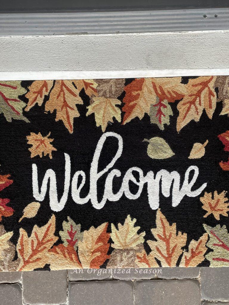 A fall rug that says welcome. Reuse it each year for a budget decorating ideas for fall porch!