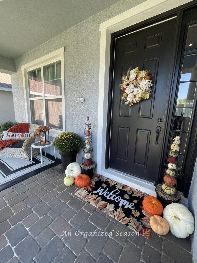 A front porch decorated for fall. 