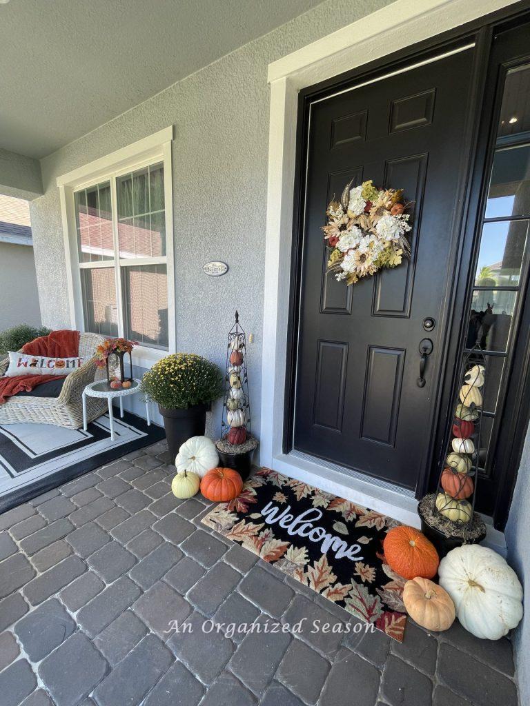 A front porch decorated for fall.