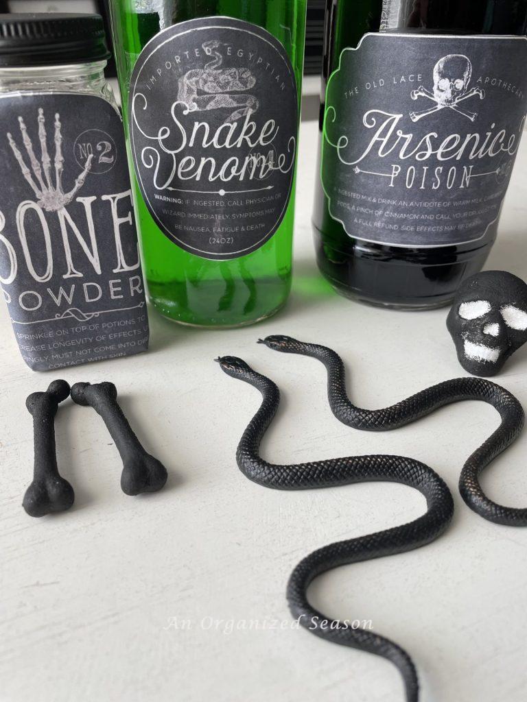 Plastic snakes, bones, and a skull used to make spooky potion bottles from jars.