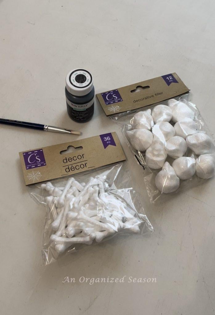 Small styrofoam skulls and bones used to make spooky potion bottles from jars.