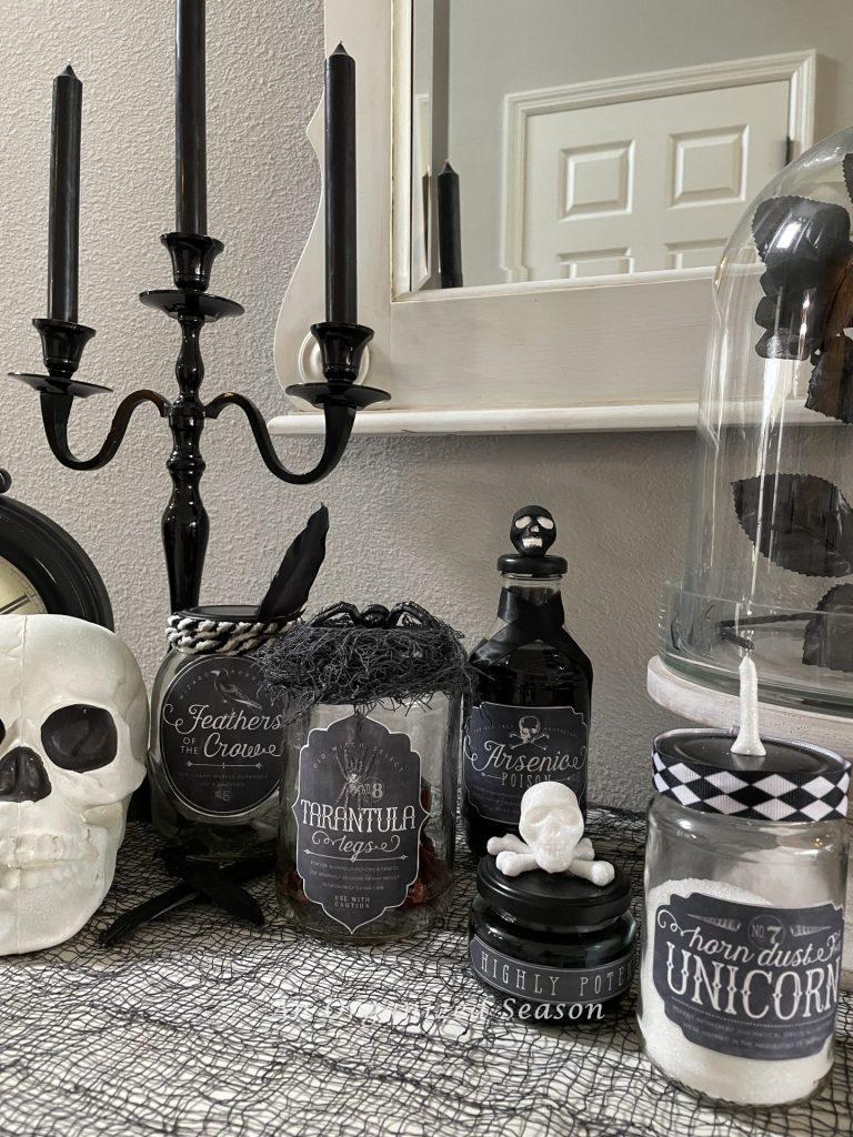 Potion bottles in front of a black candelabra.