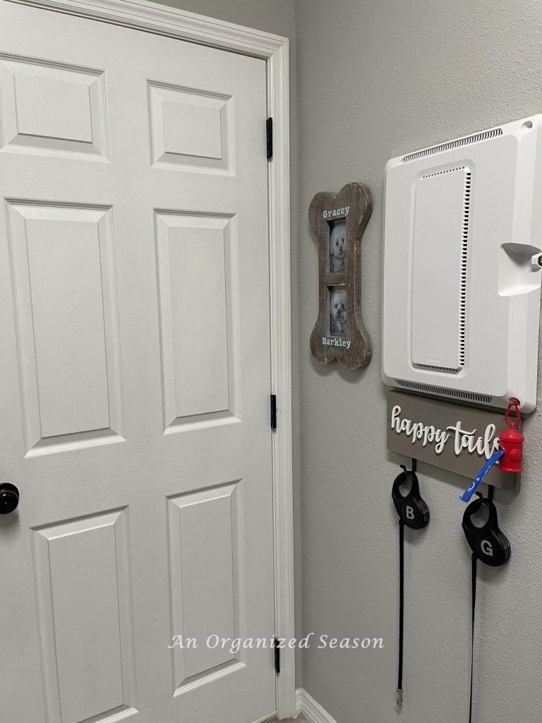 Dog leashes hanging on a sign that says "happy tails."