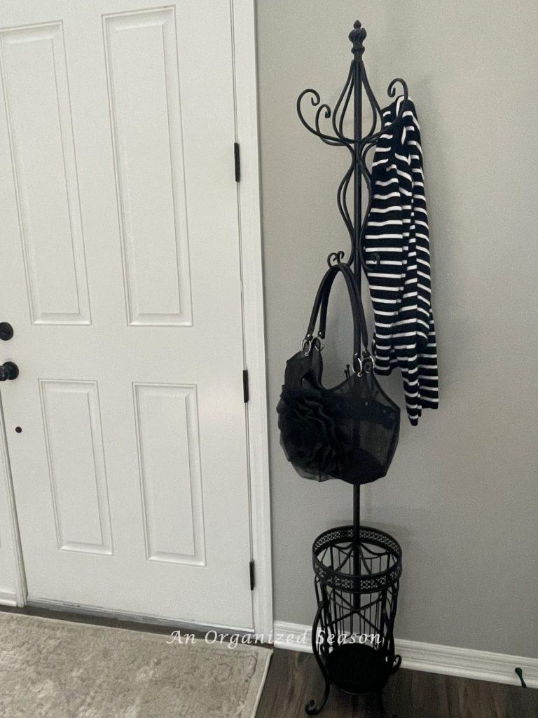 Getting a coatrack with hooks to hang a jacket and purse is  an idea to create an organized entryway! 