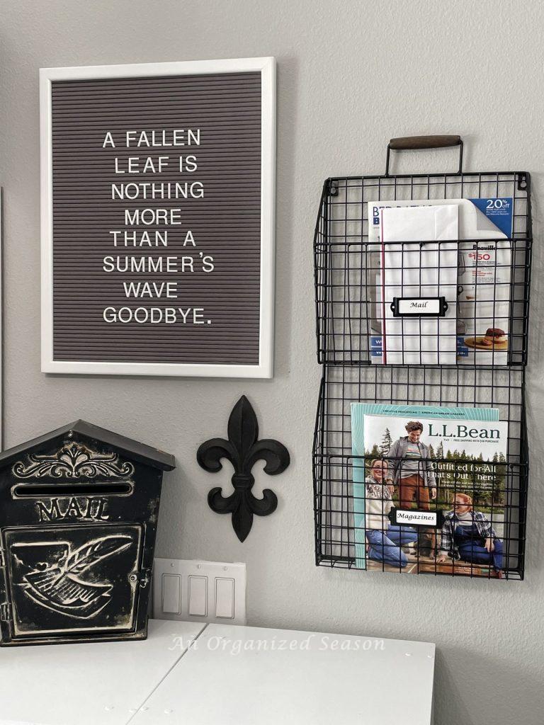 A mail station with hanging trays and a metal mailbox. 