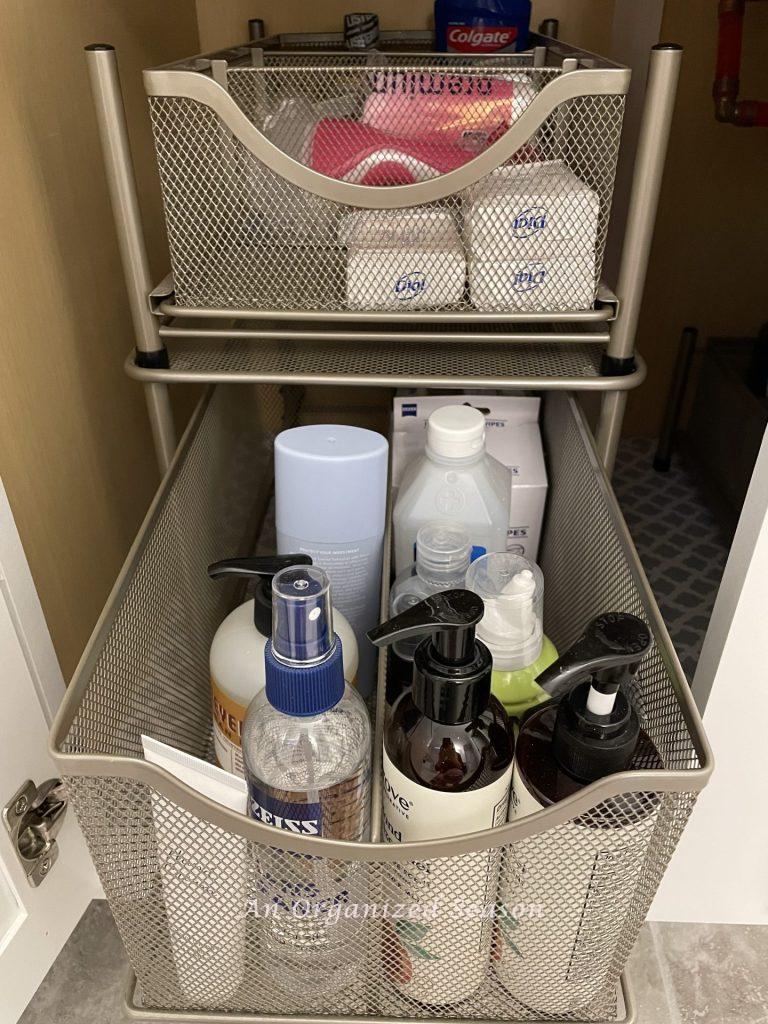 Pull out drawers storing products in a bathroom cabinet.