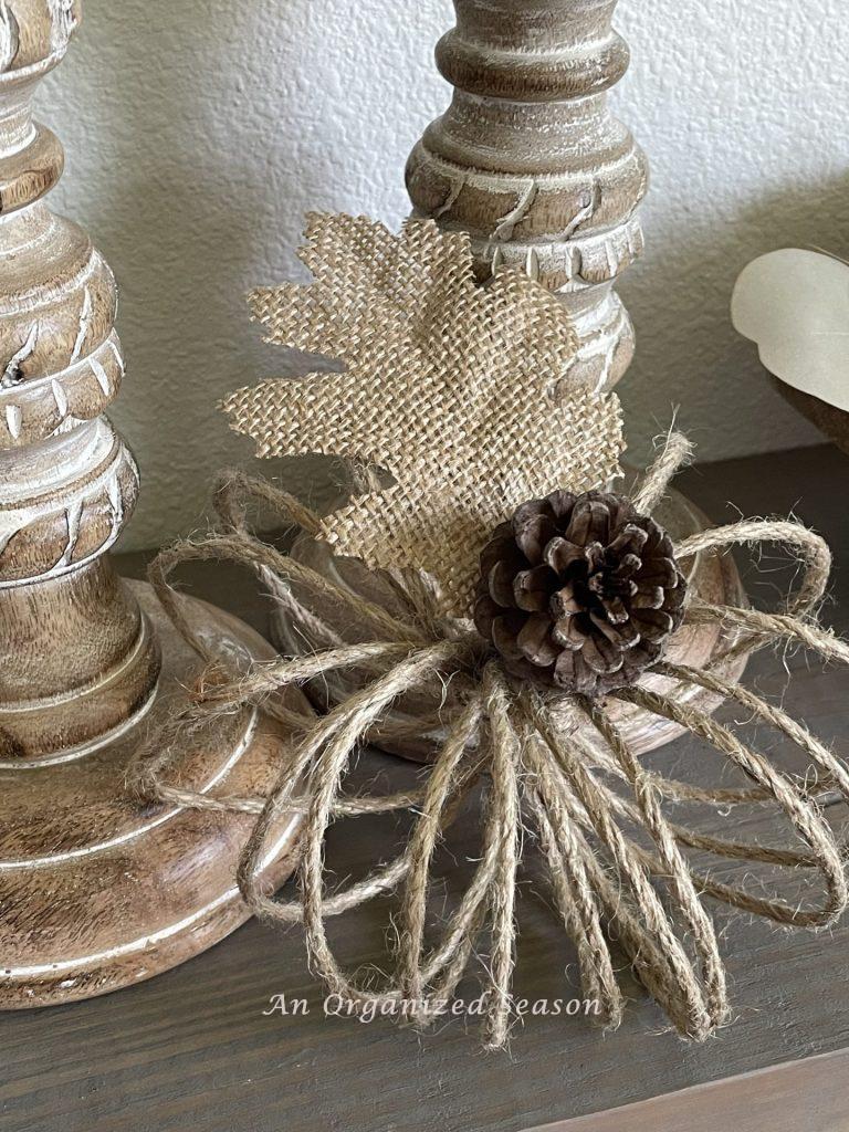 A jute twine pumpkin with a pinecone for a stem. 
