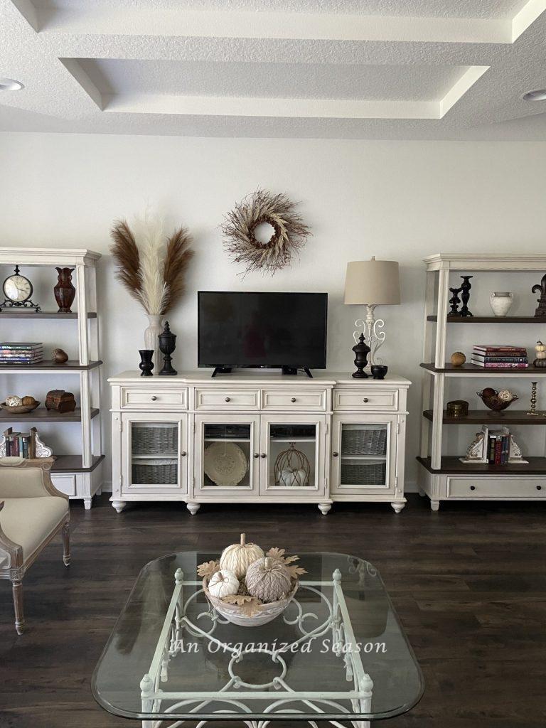 A living room with paint color SW Pure White that is decorated for a Fall Home tour. 