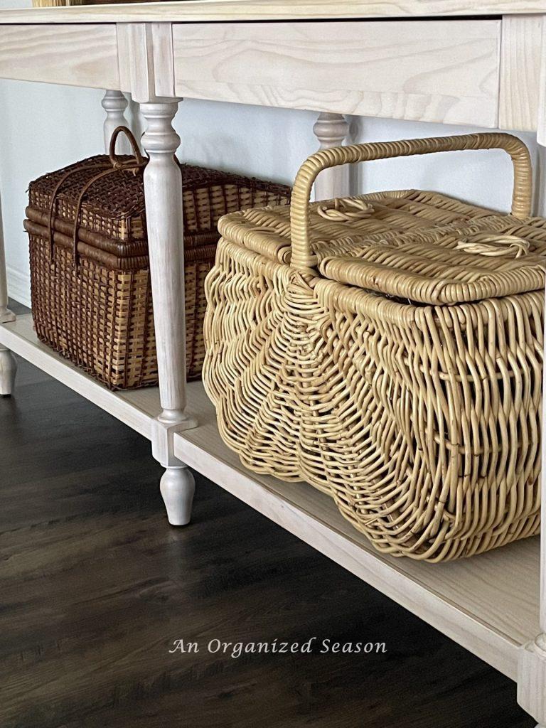 Tip two to get your living room holiday ready is to store toys inside two large baskets sitting under a console table.