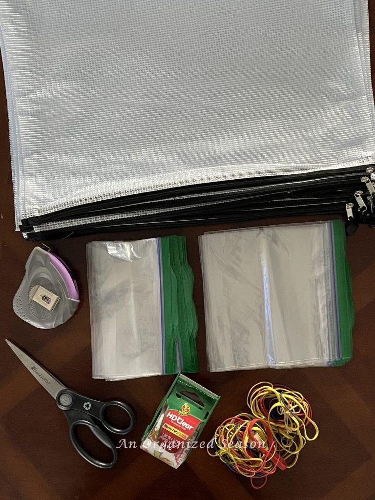 Gather zipper storage bags, scissors, rubber bands, packing tape, and tape measure to organize board games. 