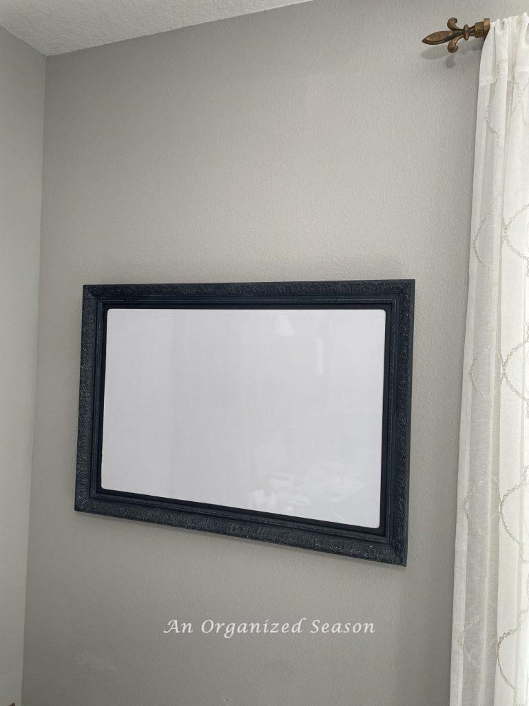 A framed whiteboard that will be used to create an ornament advent calendar. 
