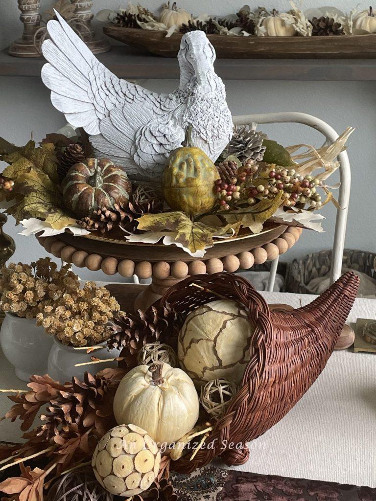 Using a turkey and cornucopia as a centerpiece, great ideas for a thrifted Thanksgiving table.