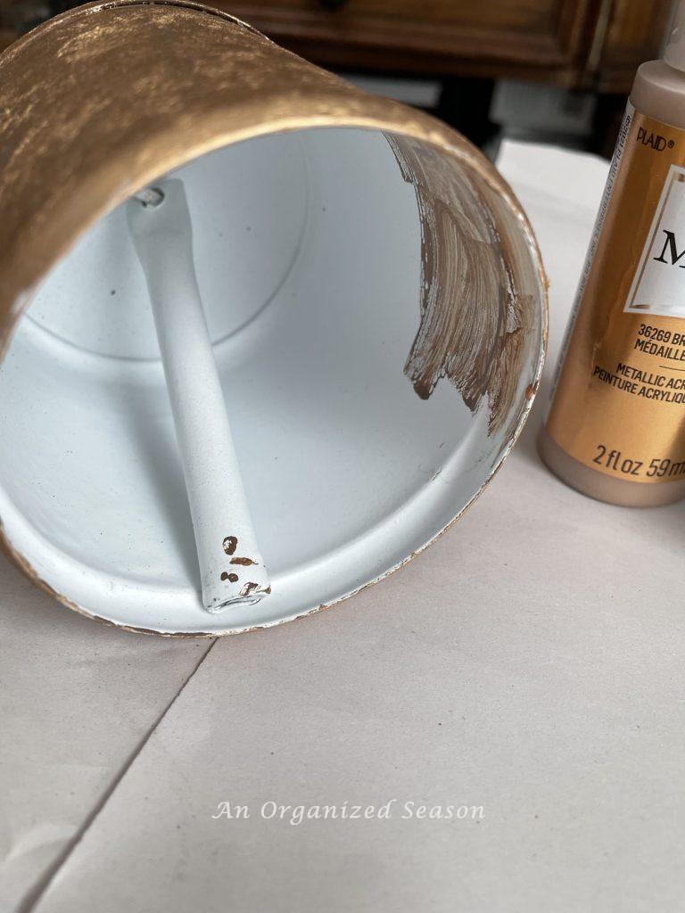 Painting the inside of a bell brown to create a Pottery Barn rustic iron bell hack.