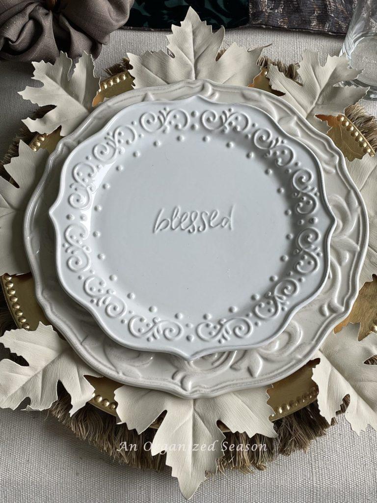 A white salad plate with the word "blessed" written on it. 