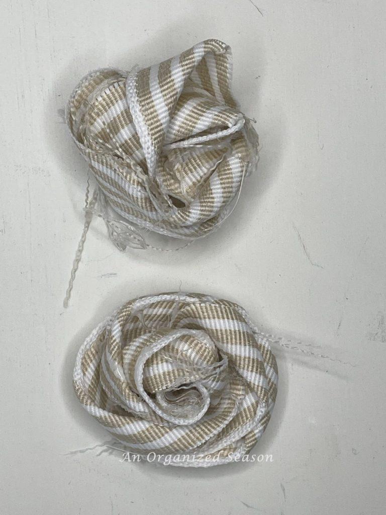 Ribbon twisted to make a rosette for a DIY cone Christmas tree. Top one is messy and bottom one is correct. 