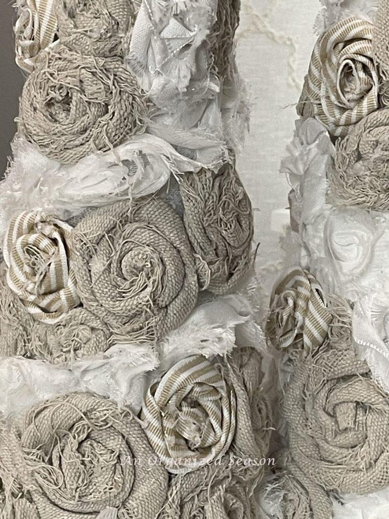 Close-up of rosettes on a DIY cone Christmas tree.