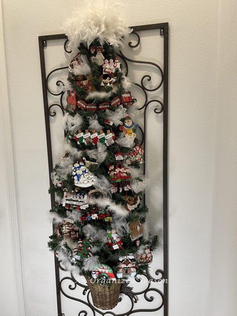 Half a Christmas tree hanging on a wall displaying our family keepsake ornament tradition.