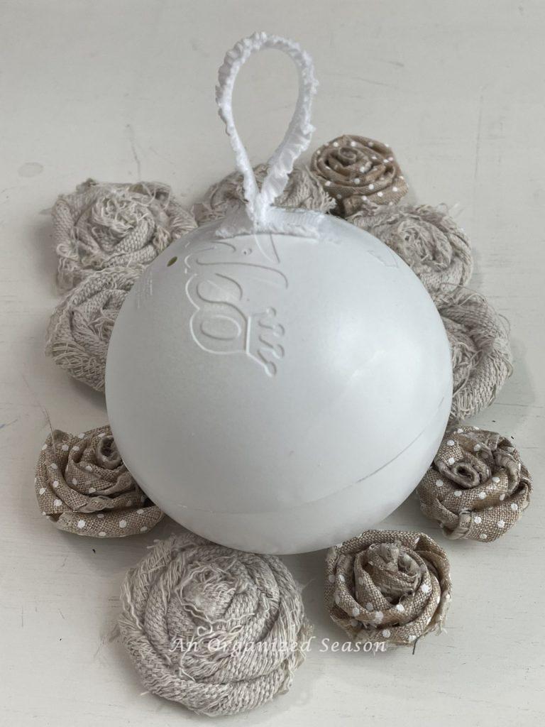 Glue white ribbon onto a plastic ball to make vintage Christmas ornaments. 