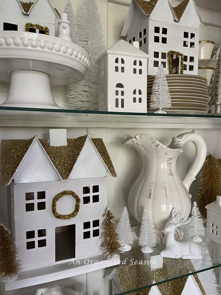 Christmas village styled with gold and white bottle brush trees.