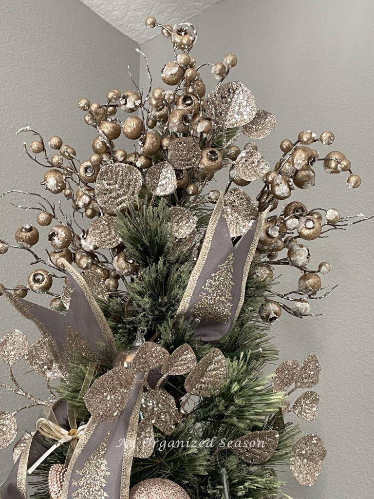 A pink Christmas tree topper in a dining room. 