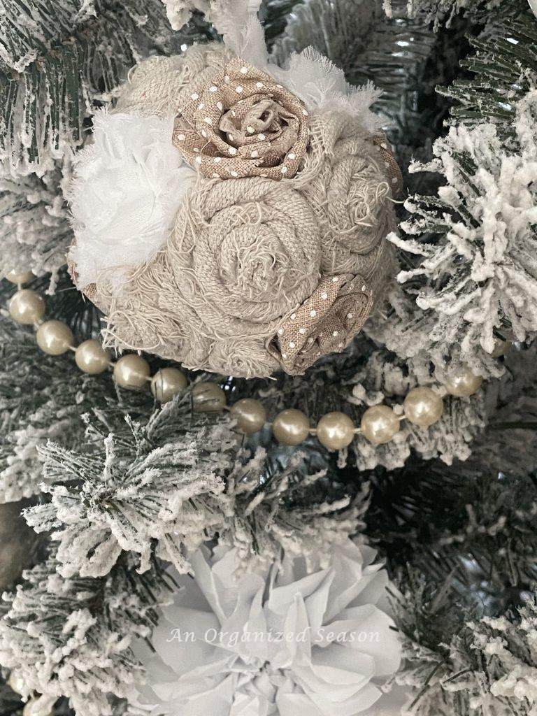 A vintage Christmas ornament made from drop cloth and ribbon rosettes. 