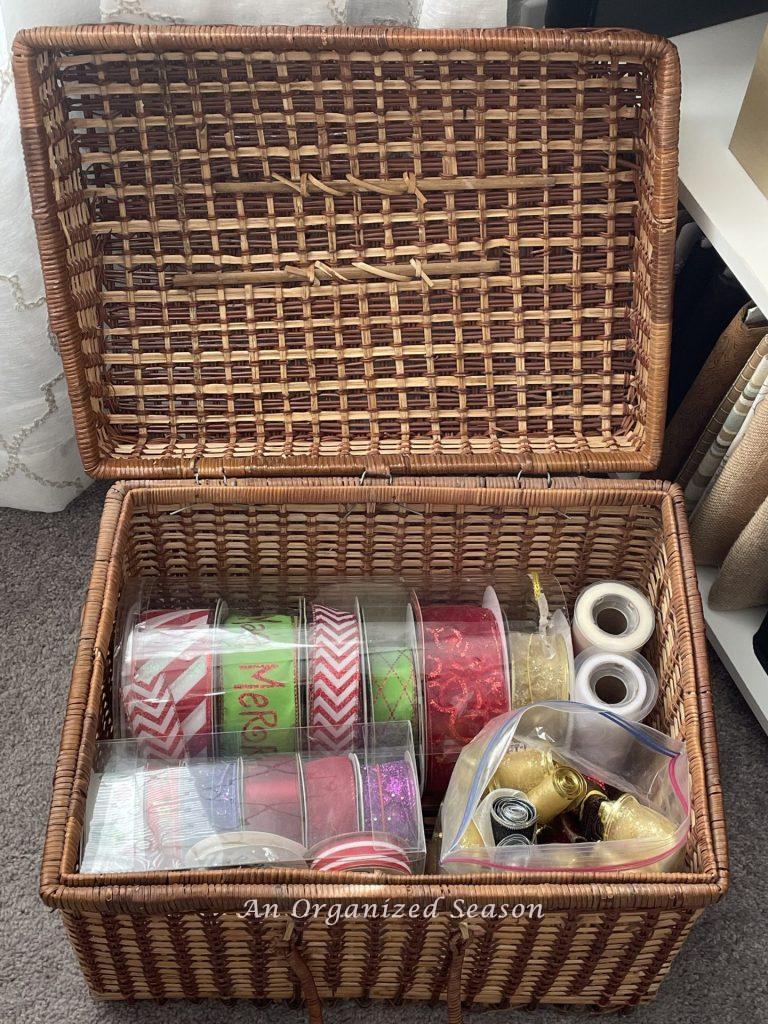 Store rolls of ribbon in clear plastic containers inside a picnic basket, great gift wrapping tips! 