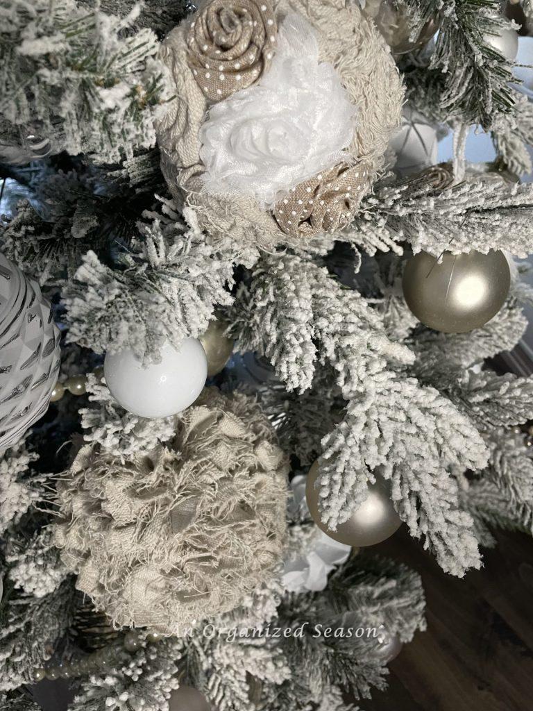 Drop cloth vintage Christmas ornaments hang on a tree. 