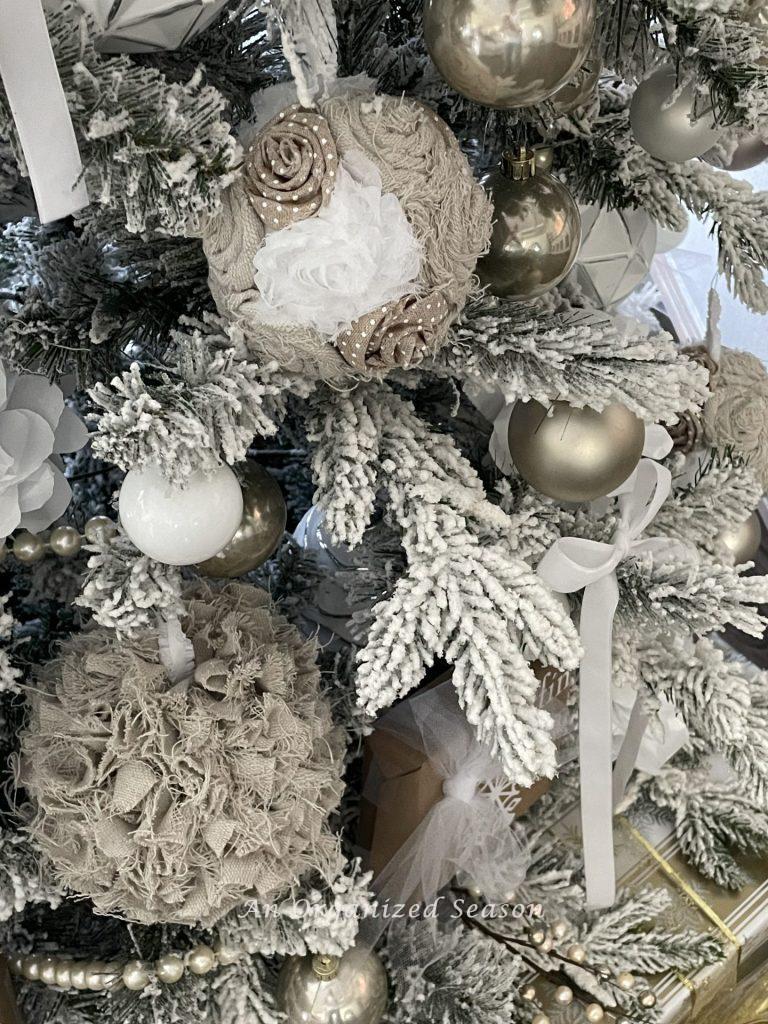 Drop cloth Christmas ornaments hanging on a tree.