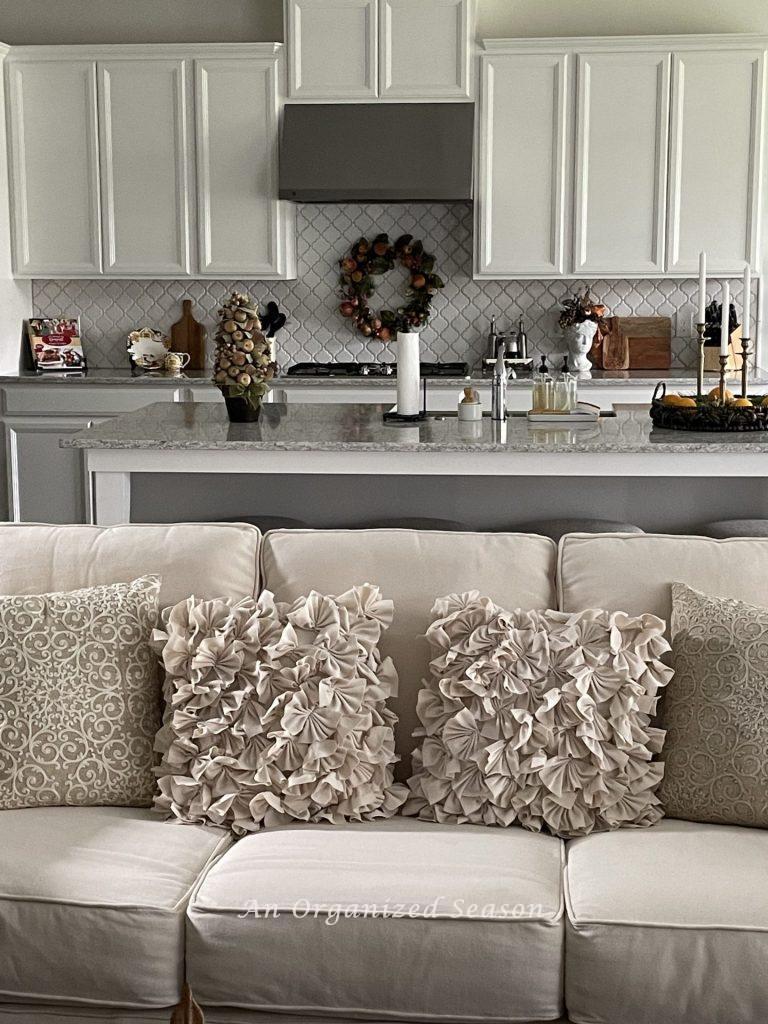 A white kitchen with Christmas decor items on the counters. 