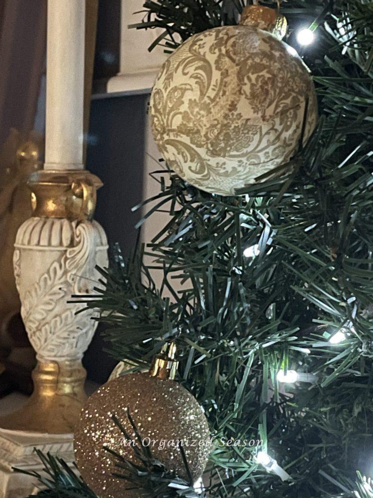 An elegant Christmas orb hanging on a tree. 