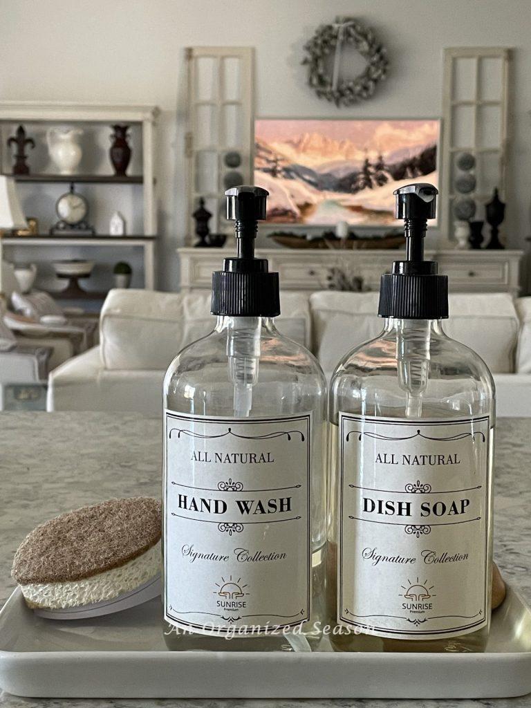 Use matching hand wash and dish soap containers on a tray to declutter and decorate your kitchen counters at the same time.  