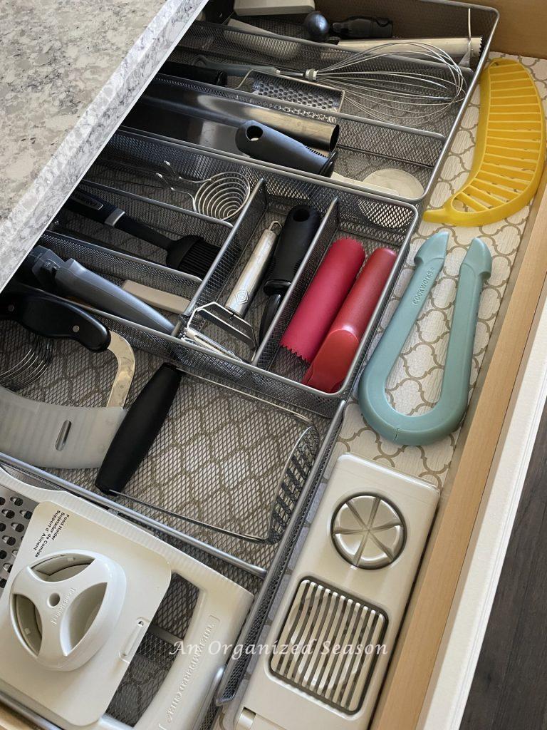 Kitchen storage solution number three is to group all of your cutting and chopping kitchen tools in a mesh wire organizer.