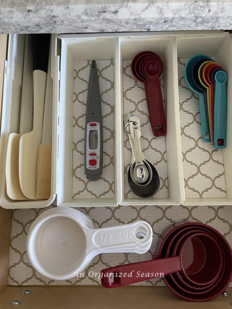 Kitchen storage solution number four is to store your measuring tools in a drawer with a kitchen divider. 