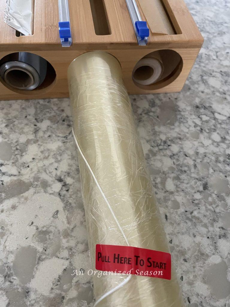 A roll of plastic wrap that is too fat to fit in a bamboo organizer.  