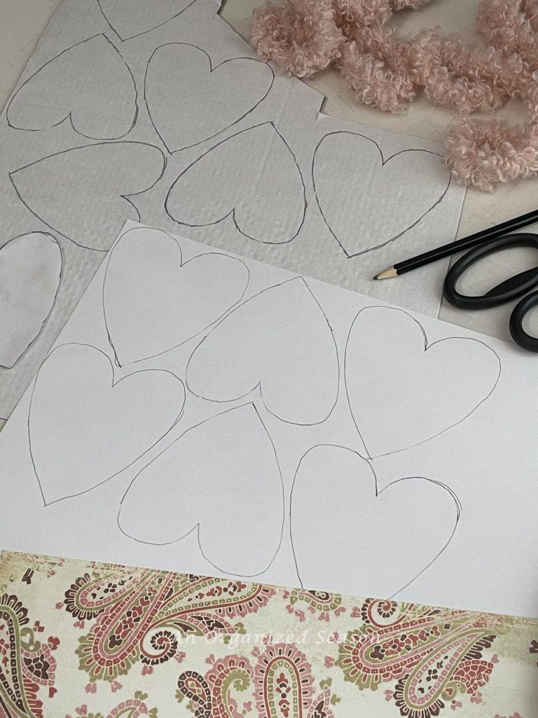 Hearts traced on a piece of paper and cardboard to make cute Valentine's decor.