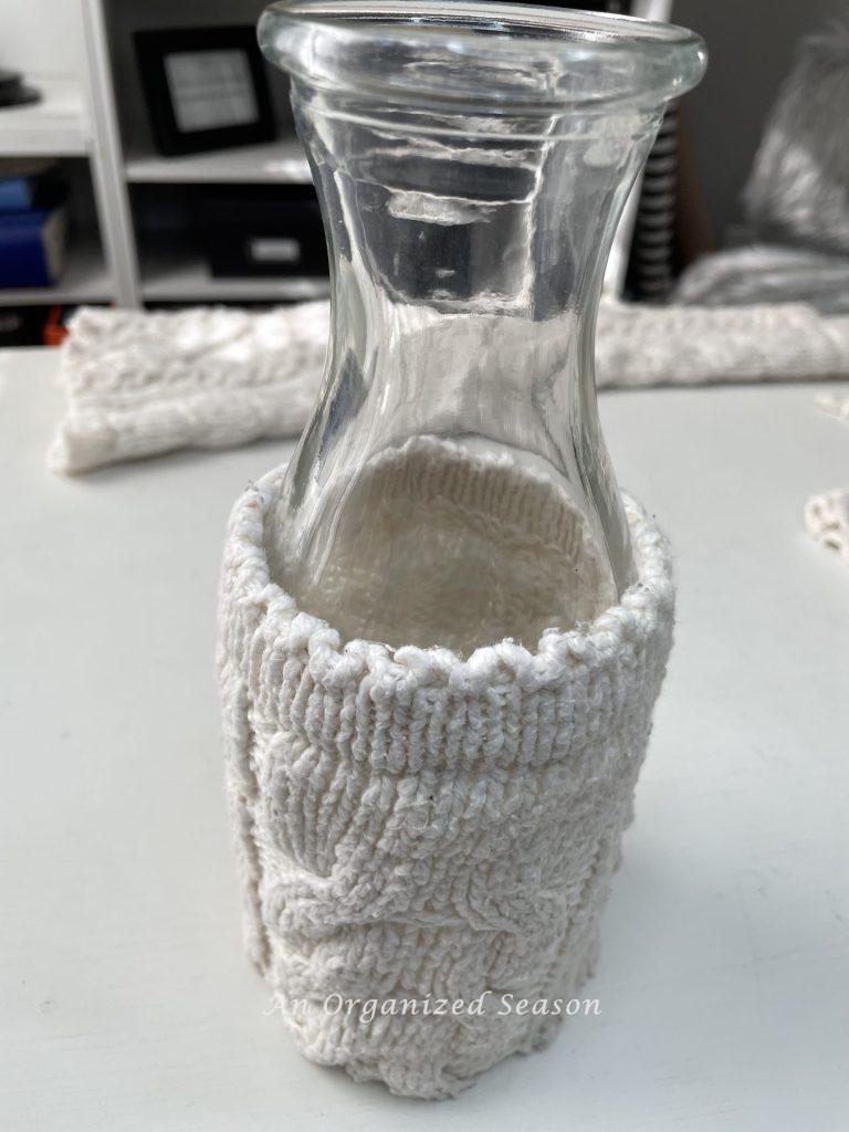 A glass vase with a sweater cozie!