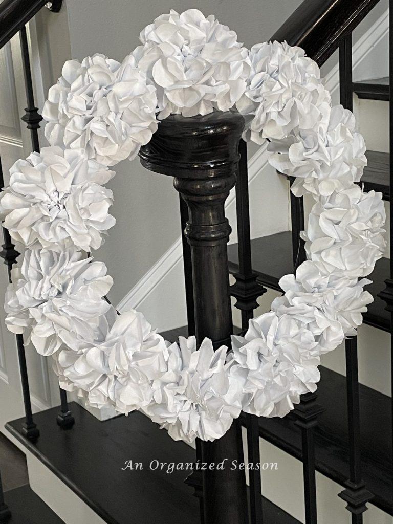 Make a creative wreath for spring out of white paper flowers.