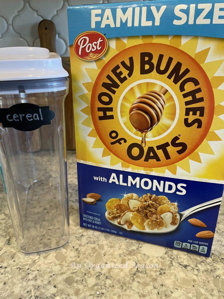 A cereal container and box of cereal showing why I love to decant items in my pantry.