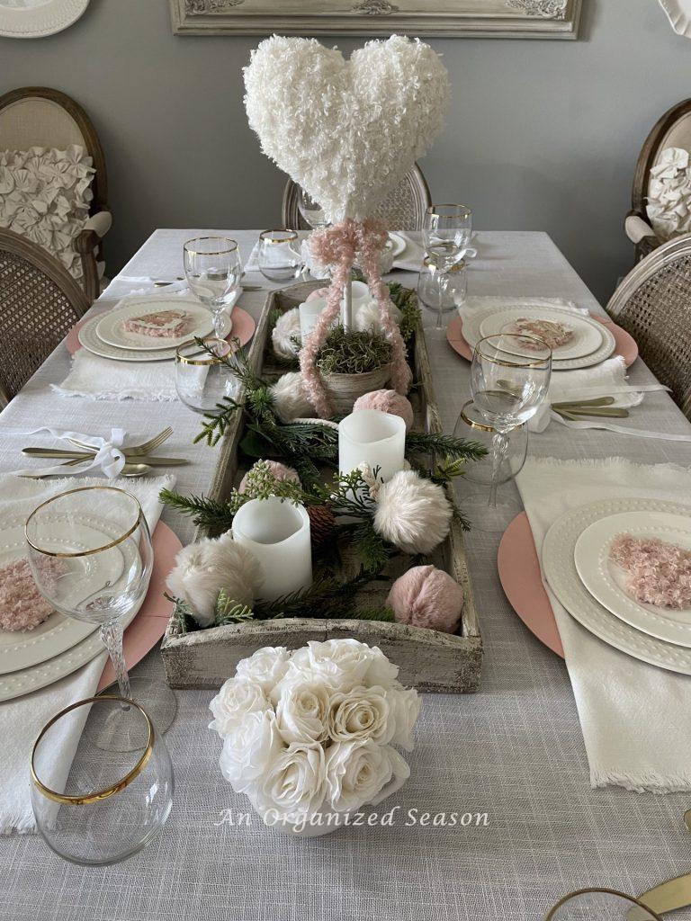 An idea for a dining room table decorated and set for Galentine's Day. 